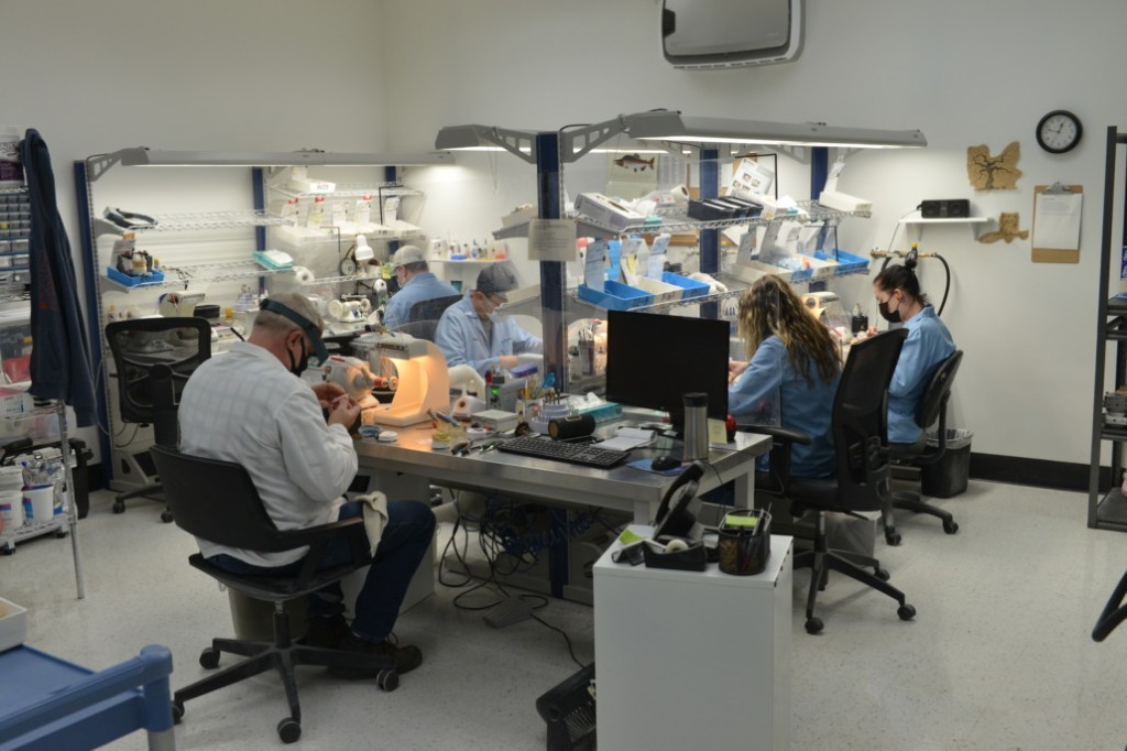 Dental lab technician working on dental model
